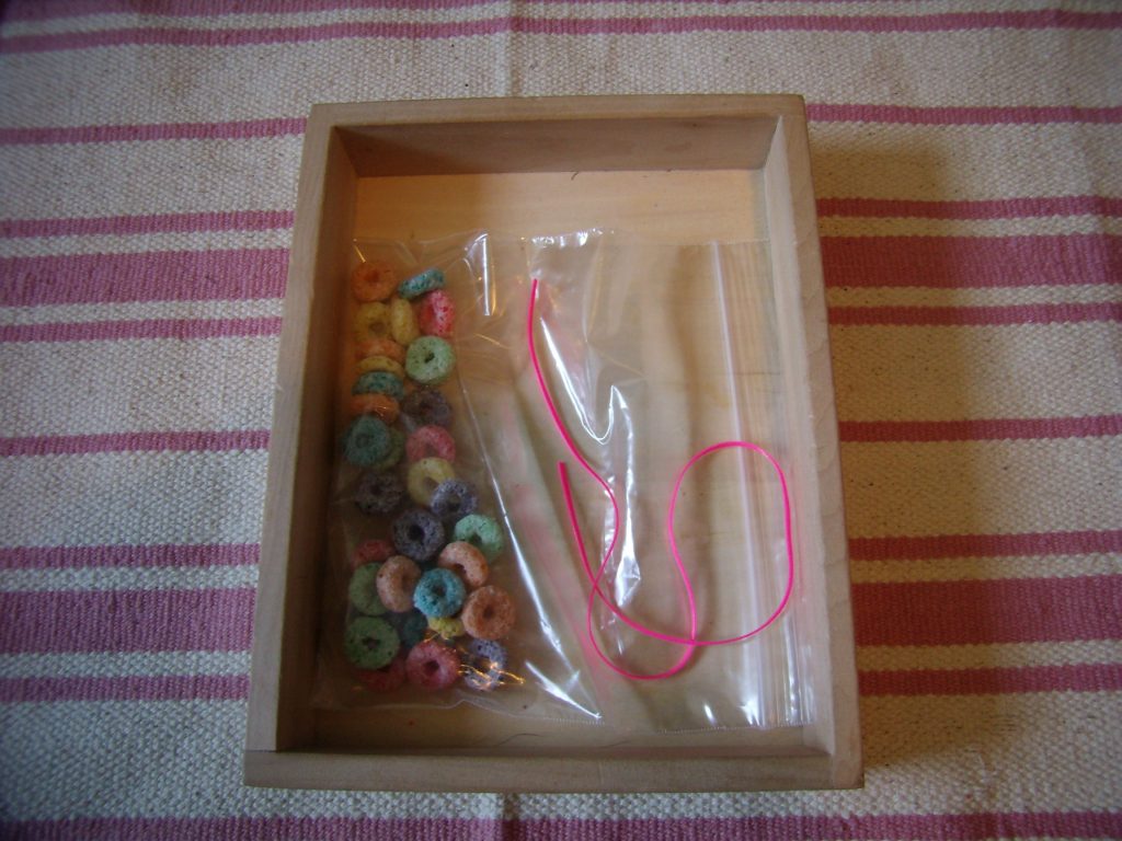 Froot Loops Necklace tray, one of many Montessori-inspired St Patricks Day Activities for Toddlers