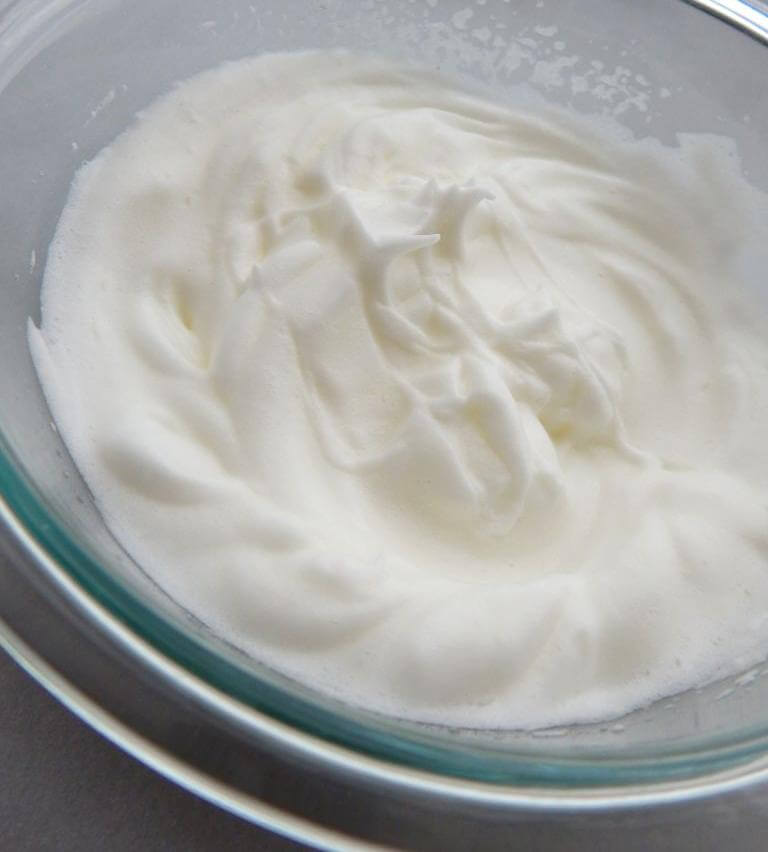 Stiff egg white peaks for making raspberry meringue cookies