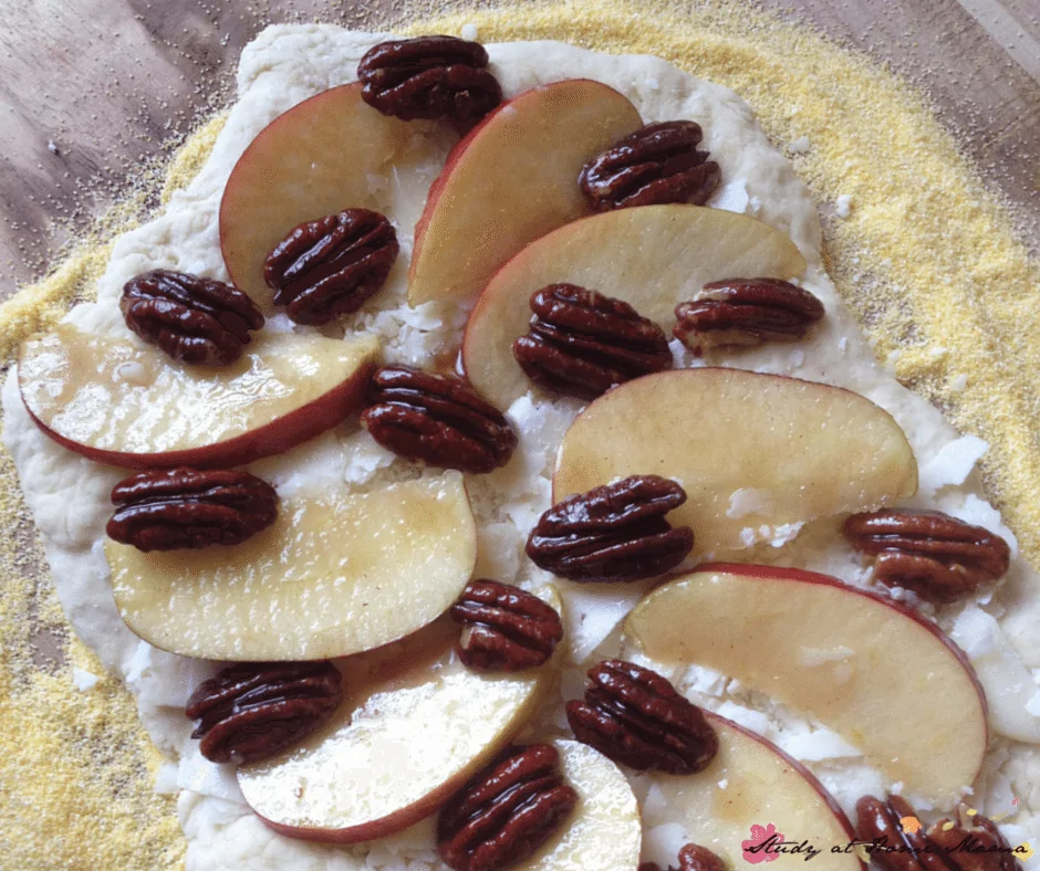 Prepping a maple-glazed pecan, apple, and parmesan homemade pizza - word to the wise, this blogger recommends adding the pecans after baking your homemade pizza!