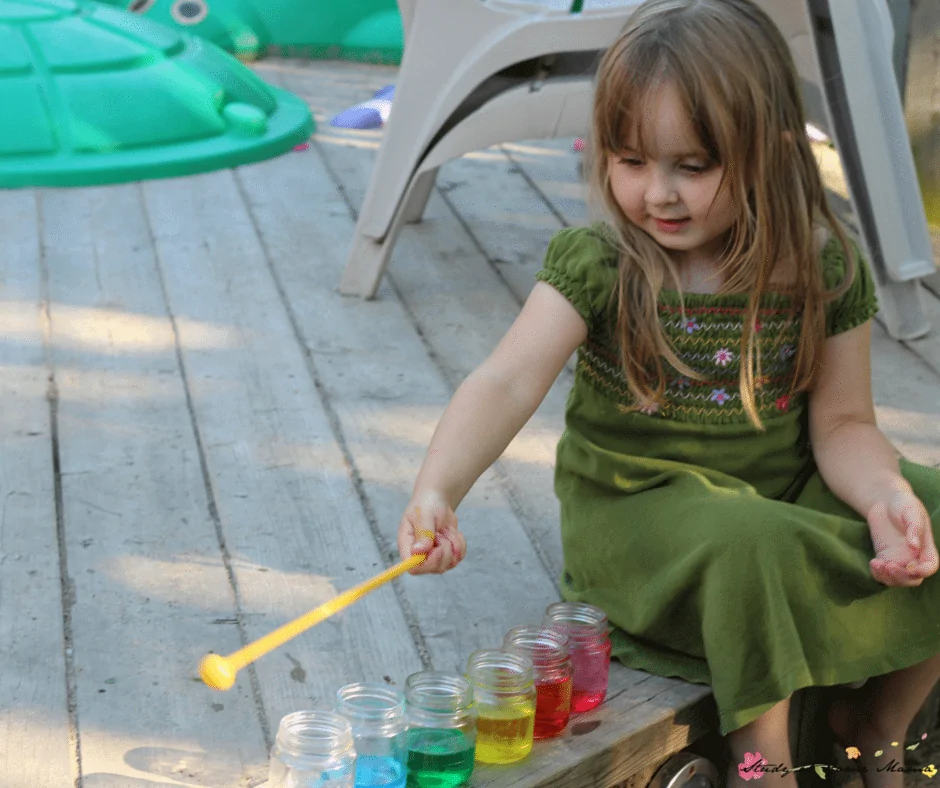 Playing with our water xylophone - a great way to mix music, science, and sensory activities for kids!