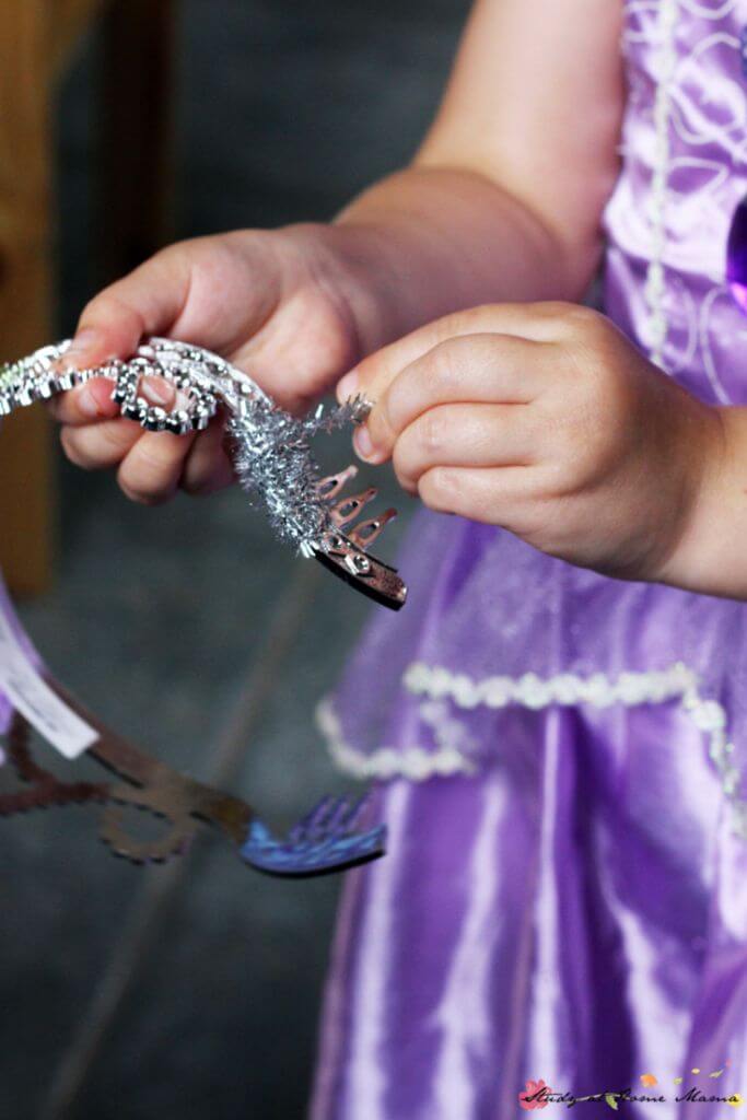Wrapping the sparkly pipe cleaner around the tiara to make a mermaid tiara craft is a great fine motor activity and can keep children's hands busy