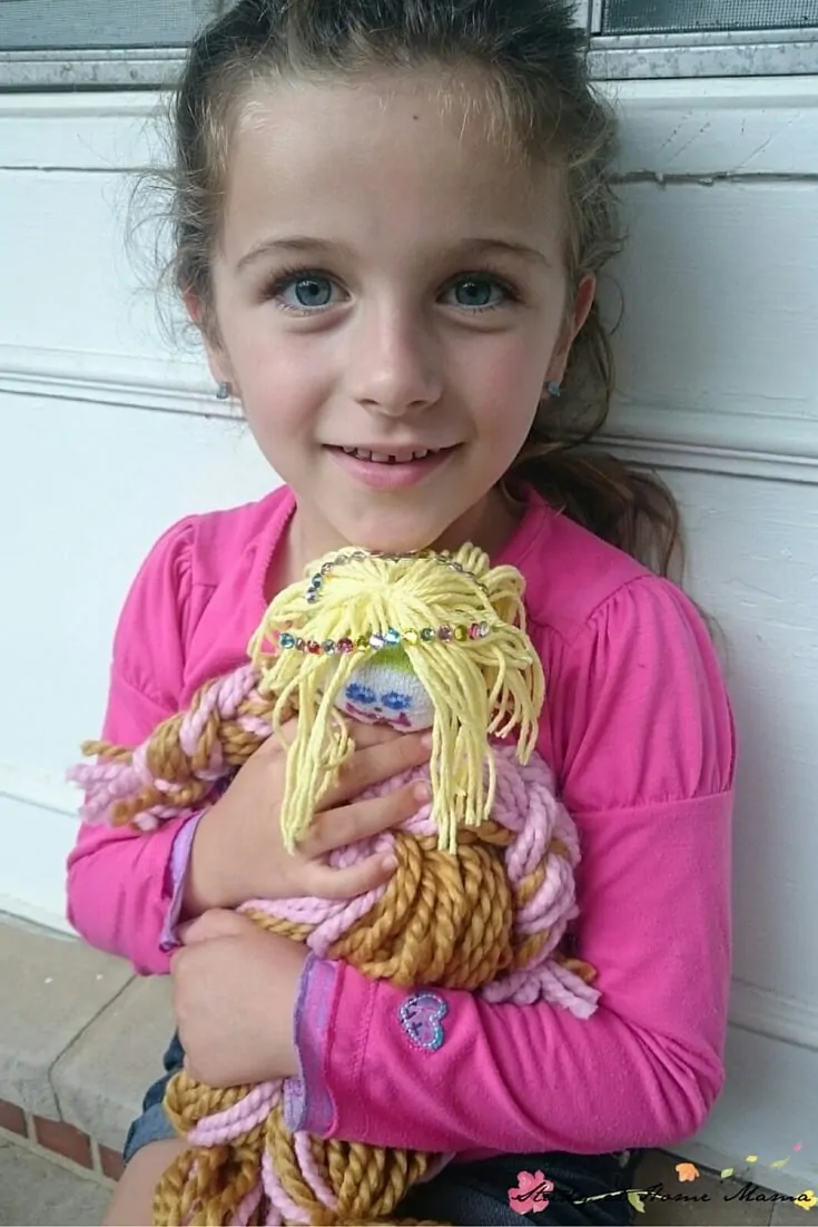 This little girl is so proud of her homemade mop doll! They are so easy to make and kids will feel so proud of making their own dolls. Click through to the blog post for full directions and materials needed.