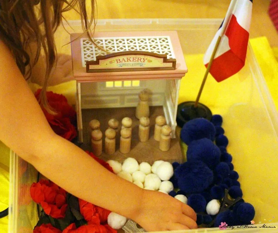 A fun Madeline sensory bin - laid out like a French flag and incorporating many symbols of French culture