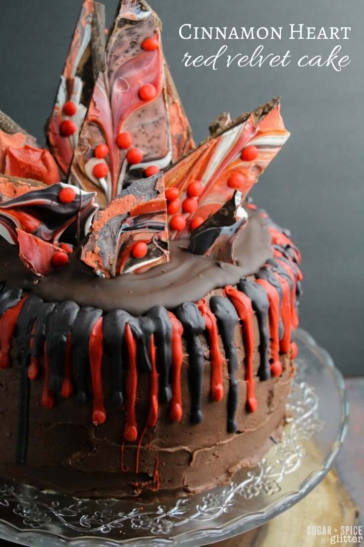 A decadent and jaw-dropping cinnamon heart red velvet cake - rich and perfectly (naturally) flavored cake with smooth, cinnamon-spiced chocolate buttercream with layers of melted chocolate and fun spikes of cinnamon heart chocolate bark