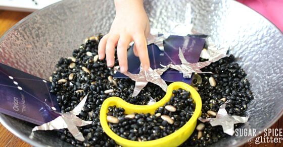astronaut sensory bin - making a constellation with our space sensory bin