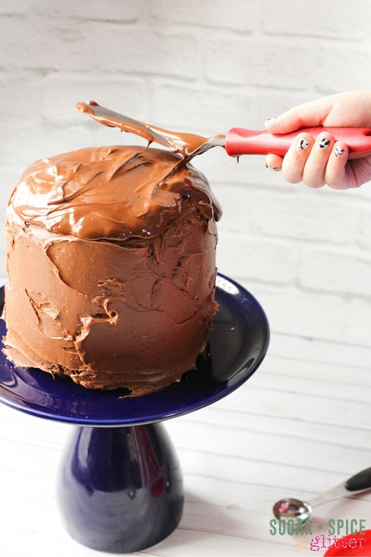 Spread that chocolate all around with an offset spatula - quadruple chocolate cake, yum!