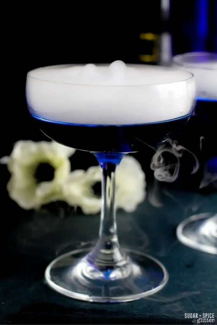 A delicious dry martini with a twist - a color changing twist! This magical color changing martini is the perfect cocktail for a Halloween party or Harry Potter themed party