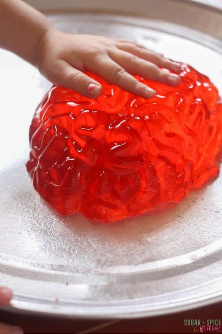 Feeling the brain - part of a Jell-O sensory play idea for Halloween
