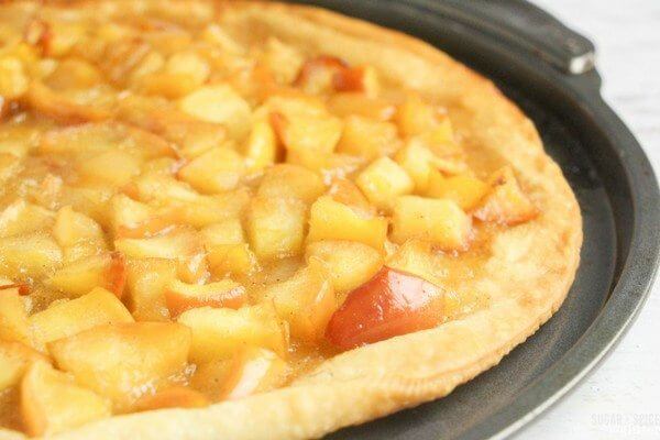 This apple pie pizza is cooked and ready for some garnish