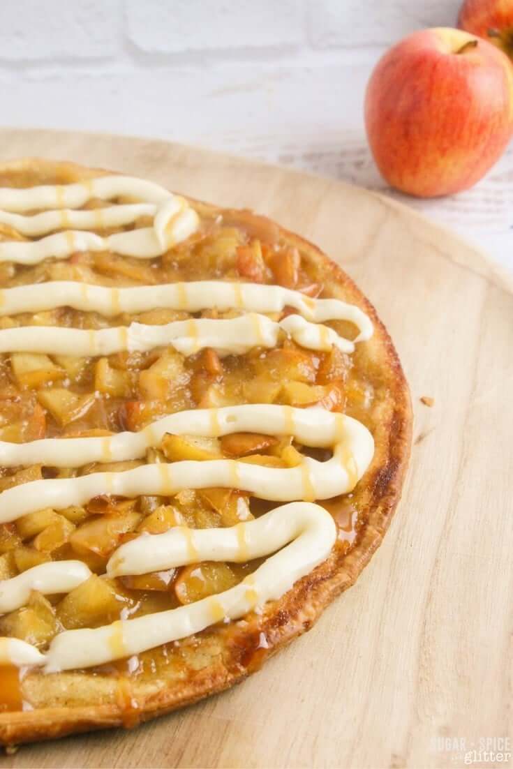 How to make a fall dessert pizza - apple pie topping, cream cheese frosting, and caramel drizzle on top of an easy butter pastry