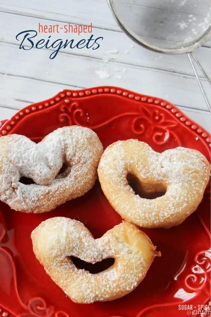 Light and crispy on the outside, soft and chewy on the inside and with a light dusting of powdered sugar, these cute heart-shaped beignets are an easy and authentic New Orleans treat perfect for Mardi Gras or for enjoying for a Princess and the Frog movie night