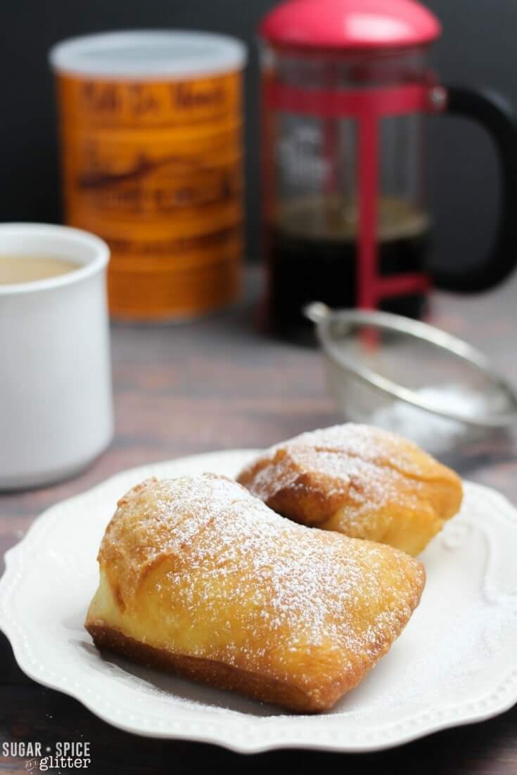 Light, crispy and chewy beignets just like you can find in New Orleans. This easy and authentic recipe will make you feel like you're sitting right on Bourbon Street at the famous Cafe Du Monde. 