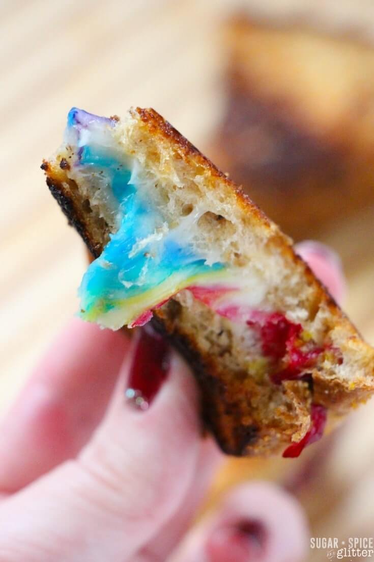 This is the sandwich you've been waiting your whole life to make. A grilled cheese sandwich that puts all others to shame - this rainbow grilled cheese is gorgeous and decadent, with two layers of ooey-gooey multicolored cheese sandiwched in between perfectly toasted artisanal bread.