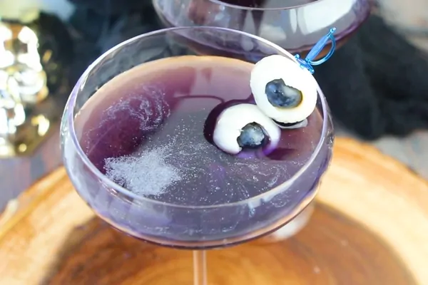 How to make a delicious purple shimmery cocktail recipe with edible fruit eyeballs