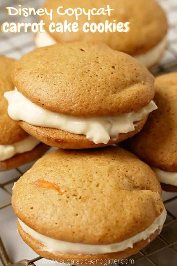 A delicious Disney copycat recipe for their famous Carrot Cake Cookies - two soft carrot cake cookies sandwiched together with tart cream cheese frosting