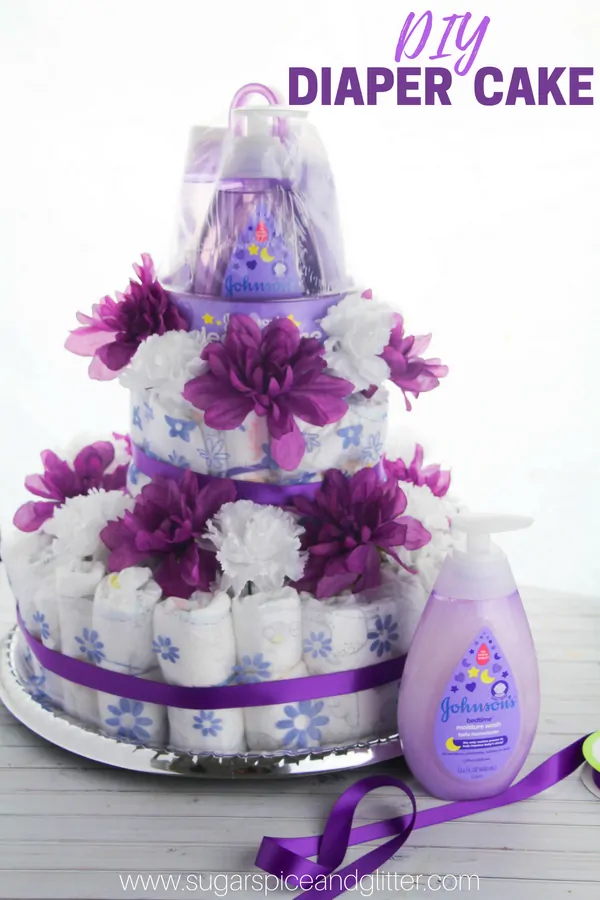 A quick and easy tutorial for the best baby shower gift ever - a DIY Diaper Cake with a white and purple color scheme. This Baby Diaper Cake is topped with Baby Bath Products for a thoughtful and useful gift for new moms-to-be.