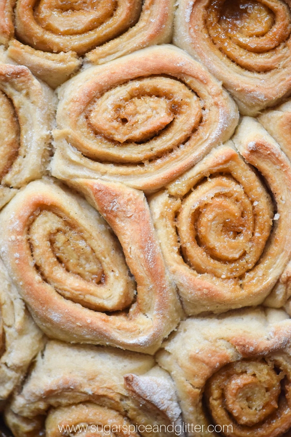 close-up image of baked pumpkin spice cinnamon rolls