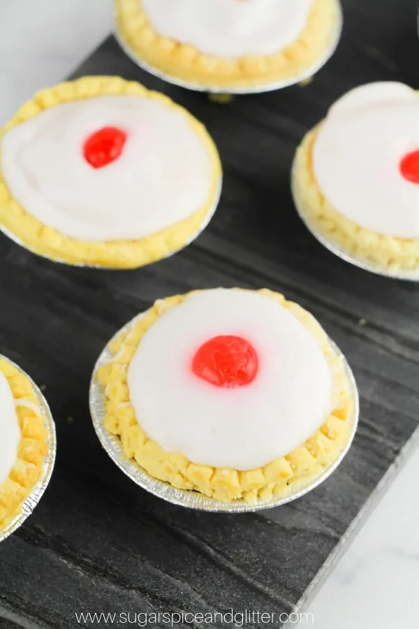 Cherry bakewell tarts on a slate tray