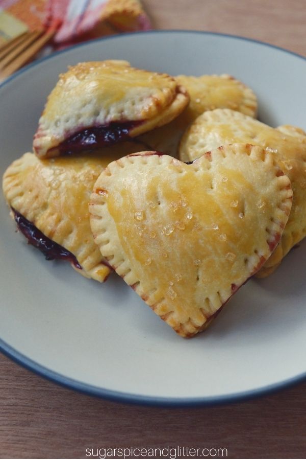 Buttery, flakey cherry hand pies in a fun heart-shape, perfect for anniversaries or Valentine's Day. This simple 4-ingredient recipe is easy enough for kids to make, too!