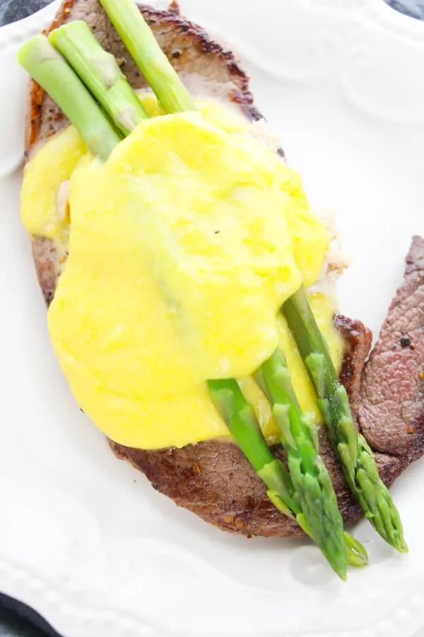 A simple panseared steak recipe topped with crab meat, asparagus and buttery bearnaise sauce