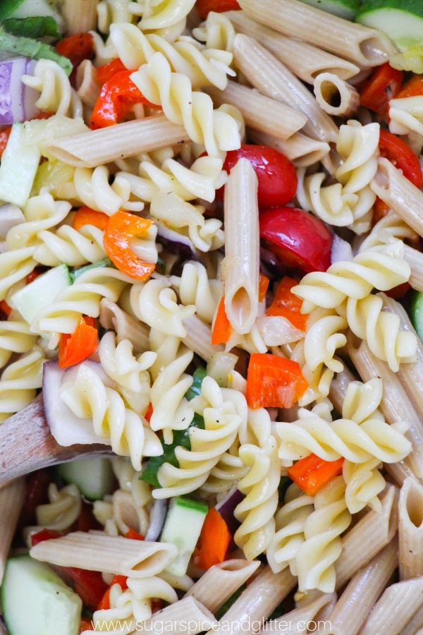 How to make a flavorful rainbow pasta salad recipe with plenty of veggies. The perfect summer pasta salad recipe