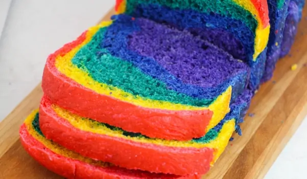 picture of sliced rainbow sandwich bread on a cutting board