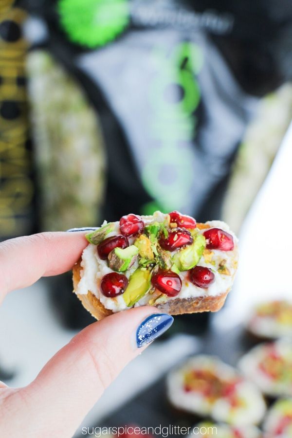 A super simple recipe for a honeyed ricotta crostini with pistachios and pomegrantes. This amazing appetizer is that perfect mix of creamy and crunchy, sweet, tangy and just a bit salty!