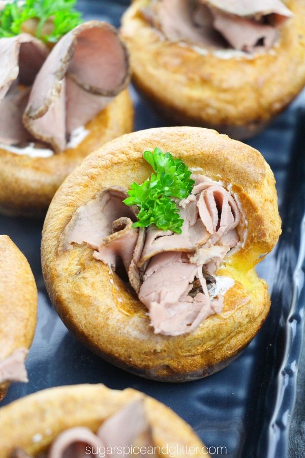 This super simple appetizer features fresh Yorkshire Puddings stuffed with homemade herb and garlic cream cheese and thinly sliced roast beef for a fun take on a comfort food classic