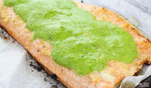 A simple baked salmon recipe with homemade chimichurri sauce - a heart-healthy meal your whole family will love