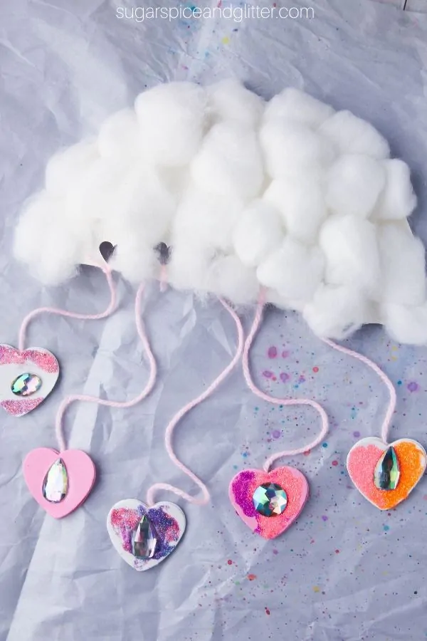 Kids build hand strength, math skills, and language skills while making this super cute Raining Love Cloud Craft to shower their loved ones with affection