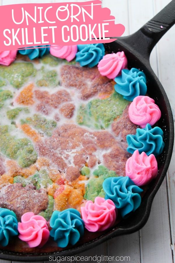 An easy unicorn skillet sugar cookie, perfect for a Unicorn Birthday if the birthday girl isn't a huge fan of cake! This decadent and delicious sugar cookie cake is topped with an iridescent, sparkly vanilla glaze and swirls of melt-in-your-mouth buttercream frosting