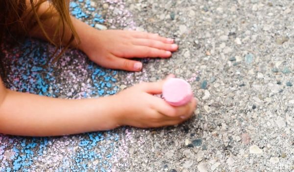 close-up of a child using homemade sidewalk chalk