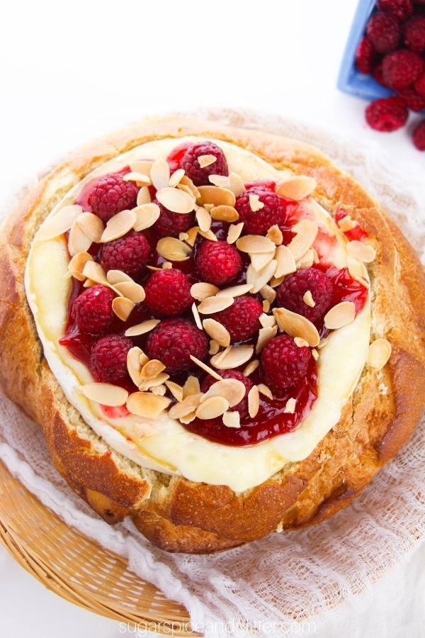 Baked Brie in Sourdough Bread with Raspberries and Toasted Almonds