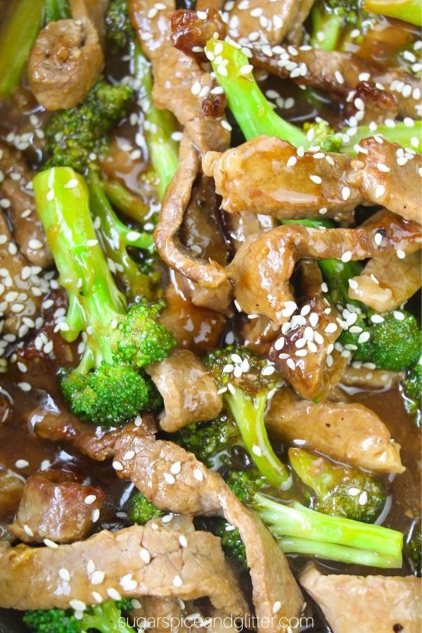 close-up image of beef and broccoli stir dry with plenty of sauce and sprinkled with sesame seeds