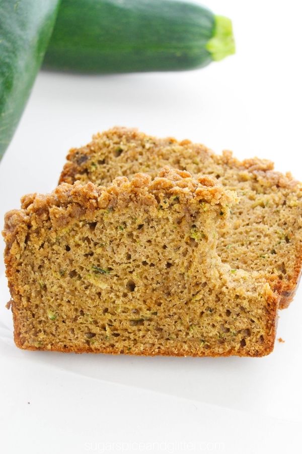 slices of zucchini coffee cake with fresh zucchini in the background