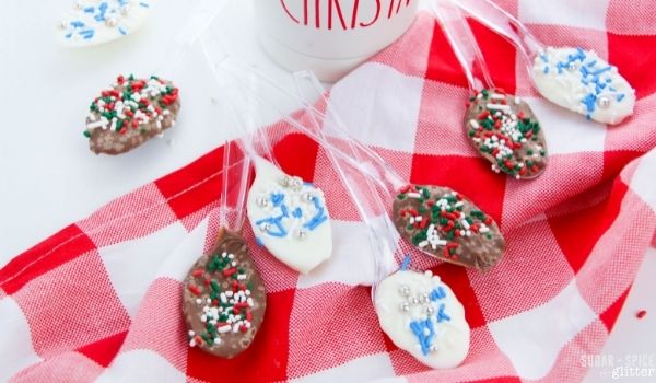 an assortment of Christmas chocolate spoons on a red plain napkin