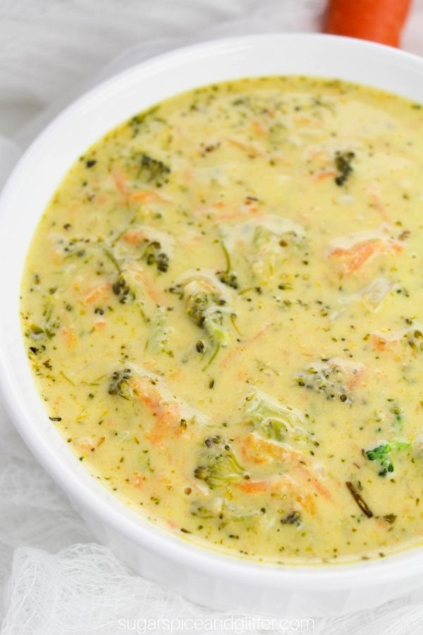 close-up image of a white bowl full of creamy broccoli cheddar soup