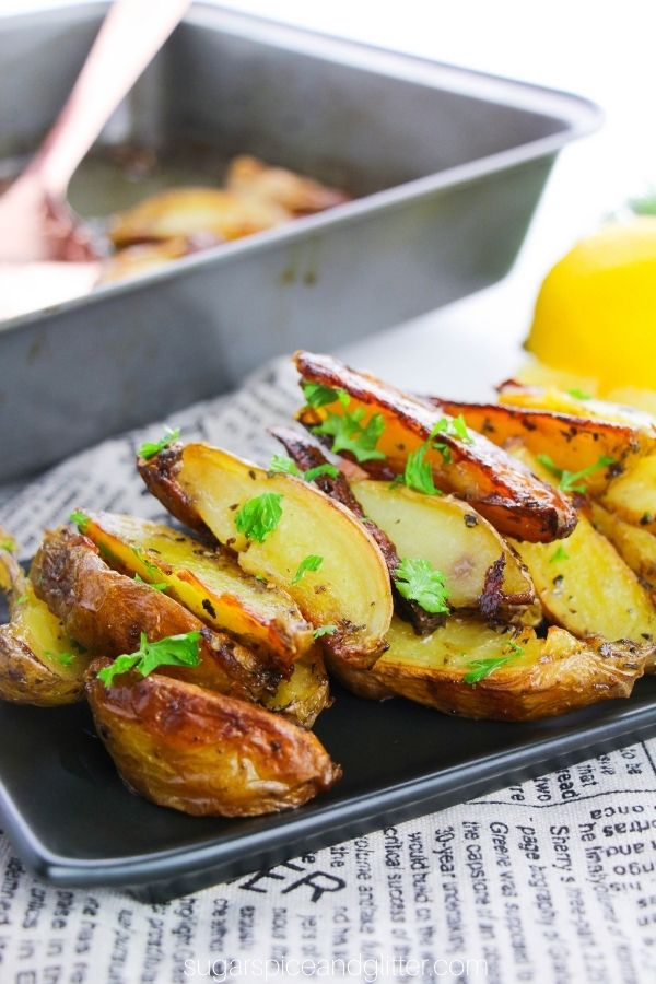 roasted Greek potatoes on a black plate