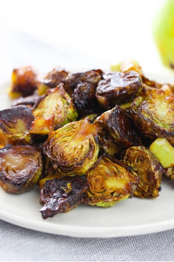 close-up image of roasted brussels sprouts and pears on a white plate