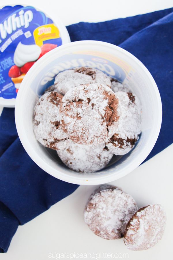 overhead image of cool whip cookies in a cool whip container on a blue napkin