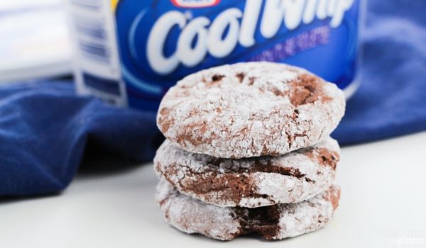 stack of cool whip cookies in front of a container of cool whip