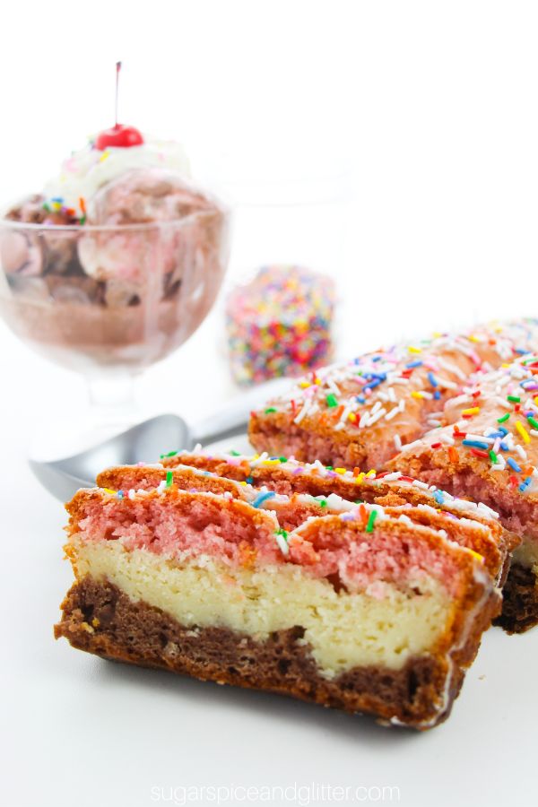 Neapolitan ice cream bread on a white table garnished with sprinkles, set beside a glass ice cream dish full of Neapolitan ice cream