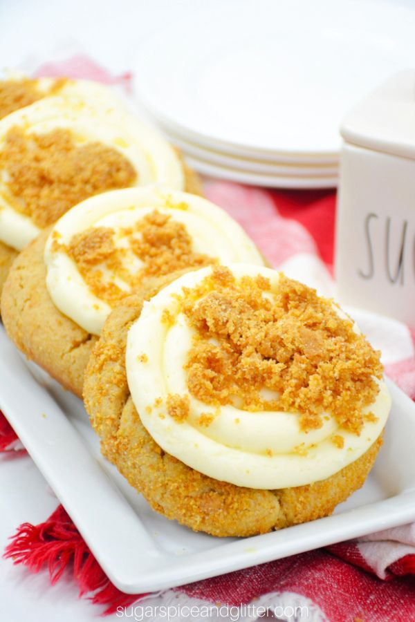 cheesecake cookies in a row on a white platter set on a red plaid napkin