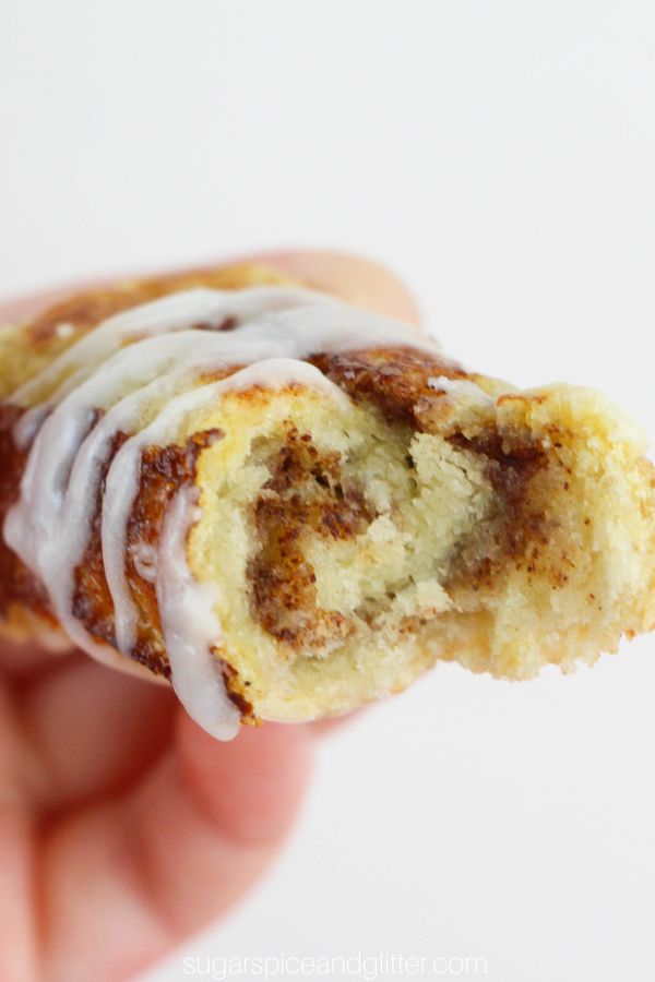 close-up of a cinnamon bun french toast roll-up with a bite taken out of it