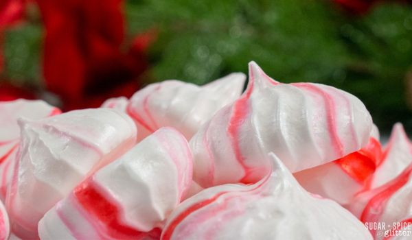 close-up image of a pile of red and white peppermint merinuges