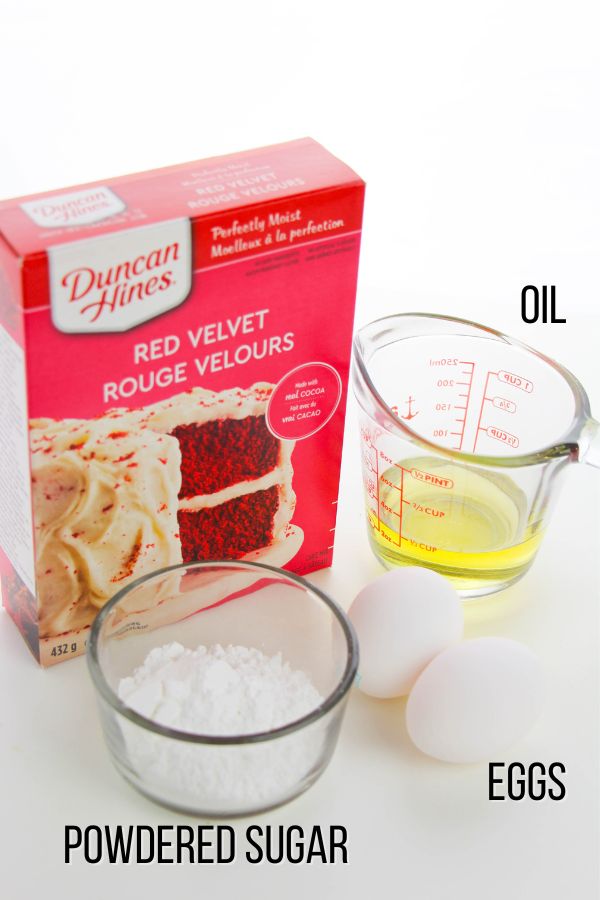 ingredients to make red velvet cake mix cookies: oil, eggs, powdered sugar, red velvet cake mix.