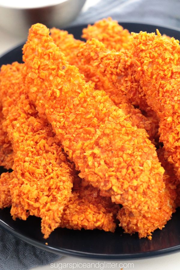 close-up image of Dorito chicken tenders on a blue plate