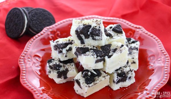 a pile of OREO fudge on a red plate with OREO cookies on the side