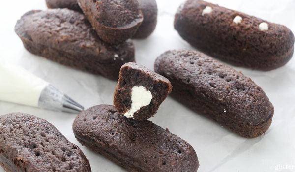 image showing a cut in half chocolate Twinkie filled with marshmallow cream