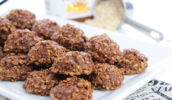 no bake nutella cookies on a white platter with ingredients to make the recipe in the background